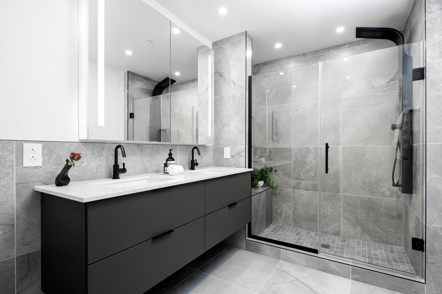Marble bathroom with double vanity and glass walk-in shower