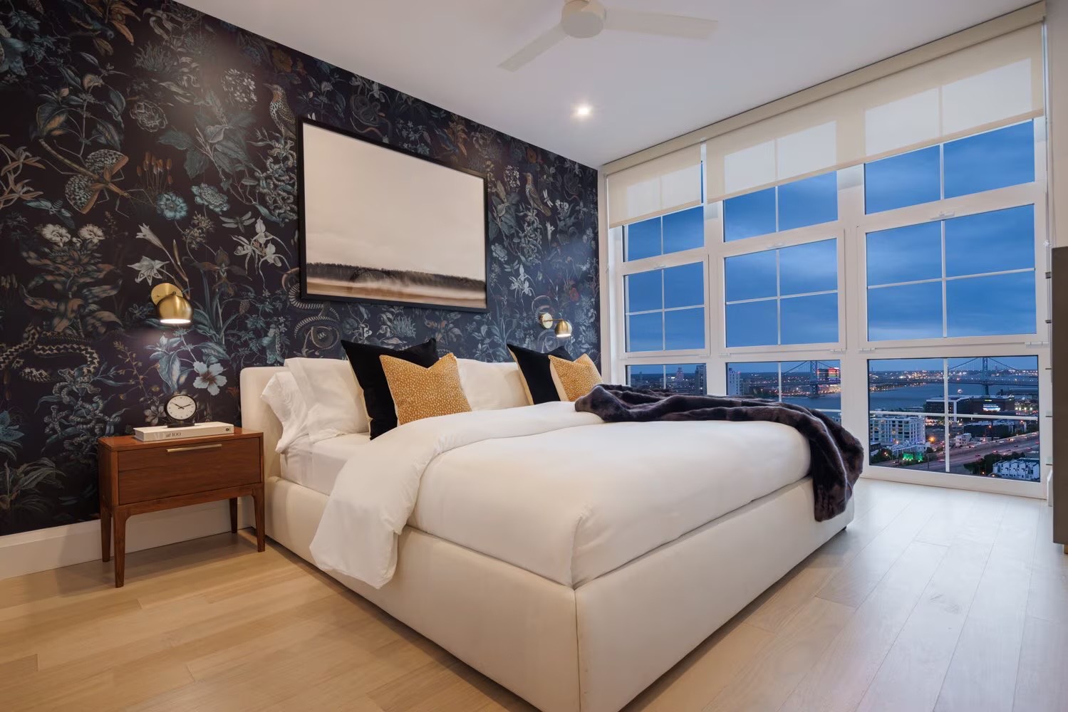 Bedroom with floral wallpaper and floor-to-ceiling river views