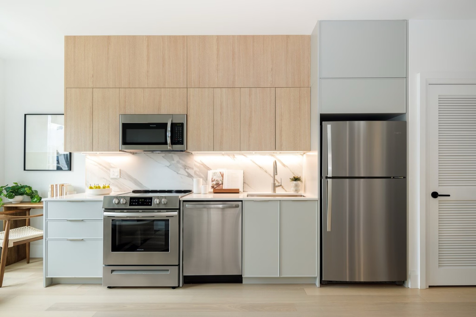 Modern kitchen with light wood cabinets and stainless appliances
